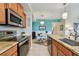 Efficient kitchen with granite countertops, stainless steel appliances, and an open layout at 803 Fairwaycove Ln # 106, Bradenton, FL 34212