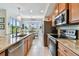 Open kitchen with granite countertops, stainless appliances and adjacent breakfast nook with large window at 803 Fairwaycove Ln # 106, Bradenton, FL 34212