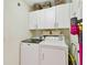 Functional laundry room featuring a modern washer and dryer with built-in storage cabinets at 803 Fairwaycove Ln # 106, Bradenton, FL 34212