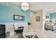 Bright office space featuring a glass desk, accent wall, and a view into the living room at 803 Fairwaycove Ln # 106, Bradenton, FL 34212