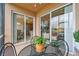Inviting screened lanai with seating, overlooking the living area, kitchen, and golf course views at 803 Fairwaycove Ln # 106, Bradenton, FL 34212