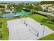 Aerial view of the sand volleyball court with well-maintained recreation area with paved parking and landscaping at 803 Fairwaycove Ln # 106, Bradenton, FL 34212