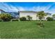 Beautifully maintained backyard with lush lawn and a screened-in lanai at 8144 37Th Avenue W Cir, Bradenton, FL 34209