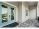 Stylish front entry with a light-blue double door, tiled porch, and coordinated window shutter at 8144 37Th Avenue W Cir, Bradenton, FL 34209