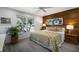 Comfortable bedroom features a wood accent wall, floral bedding, and natural light at 919 68Th Nw St, Bradenton, FL 34209