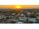 Sunset aerial view shows the neighborhood and location near the waterfront with easy access to nearby beaches at 101 Base E Ave # 101 103, Venice, FL 34285