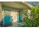 View of a back entrance with turquoise doors, plants, and decorative accents at 101 Base E Ave # 101 103, Venice, FL 34285