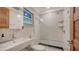 This modern bathroom features sleek fixtures, vertical tiles, and a glass-enclosed shower for a clean and stylish look at 101 Base E Ave # 101 103, Venice, FL 34285
