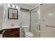 Bathroom featuring a shower with glass doors, toilet, and vanity at 101 Base E Ave # 101 103, Venice, FL 34285