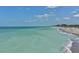 Expansive view of the beach shoreline with clear turquoise water, perfect for relaxation and recreation at 101 Base E Ave # 101 103, Venice, FL 34285