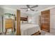 Bedroom featuring a wooden bed frame, ceiling fan, and natural light at 101 Base E Ave # 101 103, Venice, FL 34285