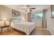 This bedroom features a ceiling fan and a window allowing natural light at 101 Base E Ave # 101 103, Venice, FL 34285