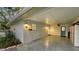 View of a large carport with a blue door, storage and a front yard at 101 Base E Ave # 101 103, Venice, FL 34285