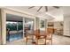 Dining area with tile floors, built-in cabinetry, and sliding doors leading to the patio at 101 Base E Ave # 101 103, Venice, FL 34285