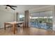 Dining room boasts modern table set and sliding glass doors to lanai at 101 Base E Ave # 101 103, Venice, FL 34285