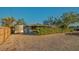 Exterior of home featuring gravel yard, greenery, and a trailer parked beside the building at 101 Base E Ave # 101 103, Venice, FL 34285