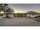 Exterior of a home at dusk with a wide driveway at 101 Base E Ave # 101 103, Venice, FL 34285