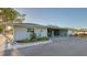 Charming single-story home featuring a spacious carport, well-maintained landscaping, and a freshly paved driveway at 101 Base E Ave # 101 103, Venice, FL 34285