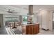 Bright kitchen featuring modern appliances, an island with cooktop and a dining area at 101 Base E Ave # 101 103, Venice, FL 34285