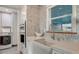 Updated kitchen with farmhouse sink, modern appliances, and mosaic tile backsplash at 101 Base E Ave # 101 103, Venice, FL 34285