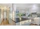 A well-lit kitchen featuring white cabinets, updated appliances, and a stylish island at 101 Base E Ave # 101 103, Venice, FL 34285