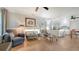 Bright living room showcasing tile flooring and comfortable furnishings adjacent to a modern kitchen at 101 Base E Ave # 101 103, Venice, FL 34285