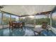 Enclosed patio with outdoor seating and lush green views, perfect for relaxing at 101 Base E Ave # 101 103, Venice, FL 34285