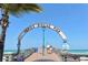 Inviting entrance to the Venice Fishing Pier with ocean views and signage on a sunny day at 101 Base E Ave # 101 103, Venice, FL 34285