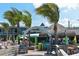 Welcoming entrance to beachside restaurant Sharky's, set among palm trees with tropical-themed decor at 101 Base E Ave # 101 103, Venice, FL 34285