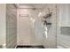 This stylish shower features subway tile, a glass block wall, and modern fixtures, creating a bright and inviting space at 101 Base E Ave # 101 103, Venice, FL 34285