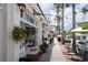 Charming street view featuring palm trees and storefronts with outdoor seating areas at 101 Base E Ave # 101 103, Venice, FL 34285