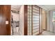 A well-organized walk-in closet features ample shelving and storage, with shoji screen and glass block detailing at 101 Base E Ave # 101 103, Venice, FL 34285