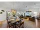 Bright living room featuring a dining area, vaulted ceilings, and a decorative tarpon fish on the wall at 101 Tern Dr, Anna Maria, FL 34216