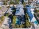 Aerial view of a modern home with a private pool, outdoor lounge area, and lush landscaping at 108 Magnolia Ave, Anna Maria, FL 34216