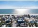 Stunning aerial view of a beachfront home with direct access to the ocean and white sand beaches at 108 Magnolia Ave, Anna Maria, FL 34216
