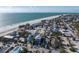 Aerial view of a charming beachside neighborhood with a beautiful home near the white sand and the blue ocean at 108 Magnolia Ave, Anna Maria, FL 34216