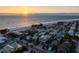 Panoramic aerial view of a coastal community near the beach, showcasing neighborhood homes and ocean views at 108 Magnolia Ave, Anna Maria, FL 34216