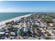 Aerial view showcasing a stunning beachfront property with a beautiful beach and waterfront community at 108 Magnolia Ave, Anna Maria, FL 34216