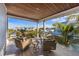 Outdoor balcony with seating offers relaxing place with views of the neighborhood and blue skies at 108 Magnolia Ave, Anna Maria, FL 34216