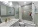 Charming bathroom with a tub-shower combo, patterned tile, and a stylish vanity with a large mirror at 108 Magnolia Ave, Anna Maria, FL 34216