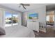 Bright bedroom with a view to the outside and a flat screen tv at 108 Magnolia Ave, Anna Maria, FL 34216