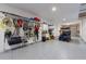 Spacious garage featuring ample storage space, a golf cart, and epoxy flooring at 108 Magnolia Ave, Anna Maria, FL 34216