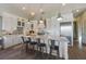 Open kitchen boasts stone counters, stainless steel appliances, and large barstool seating at 108 Magnolia Ave, Anna Maria, FL 34216