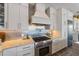 Gourmet kitchen with stainless steel appliances, stone countertops and custom backsplash at 108 Magnolia Ave, Anna Maria, FL 34216