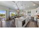 Modern kitchen with a granite island, stainless steel appliances, and dining area at 108 Magnolia Ave, Anna Maria, FL 34216