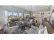 An airy living room shows an area rug, a large couch and plenty of natural light at 108 Magnolia Ave, Anna Maria, FL 34216