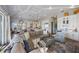 Spacious living room features a large sectional sofa, island seating and lots of natural light at 108 Magnolia Ave, Anna Maria, FL 34216