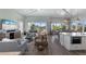 Bright and airy living room featuring large windows, comfortable seating, and an open floor plan at 108 Magnolia Ave, Anna Maria, FL 34216