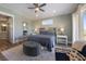Spacious main bedroom features a ceiling fan, an area rug and wood floors at 108 Magnolia Ave, Anna Maria, FL 34216