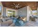 Relaxing covered porch with ample seating and a breezy atmosphere at 108 Magnolia Ave, Anna Maria, FL 34216